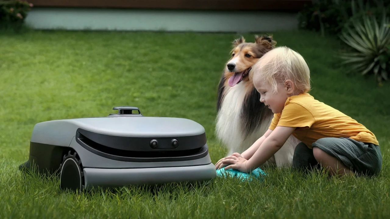 Robot tondeuse Oasa R1 sur le gazon avec un enfant et un chienb